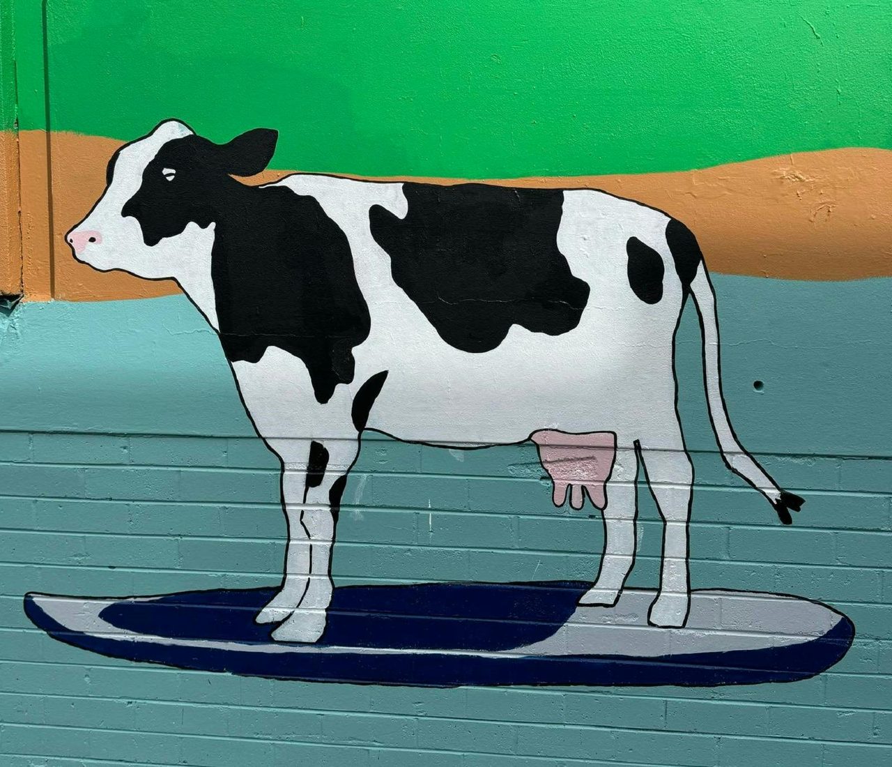 Cow surfing along the Wilsons River in mural