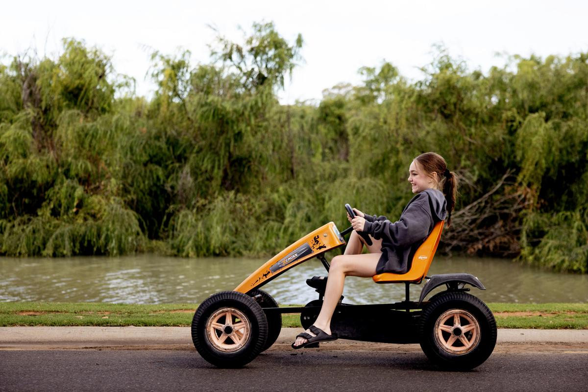 child riding pedal kart