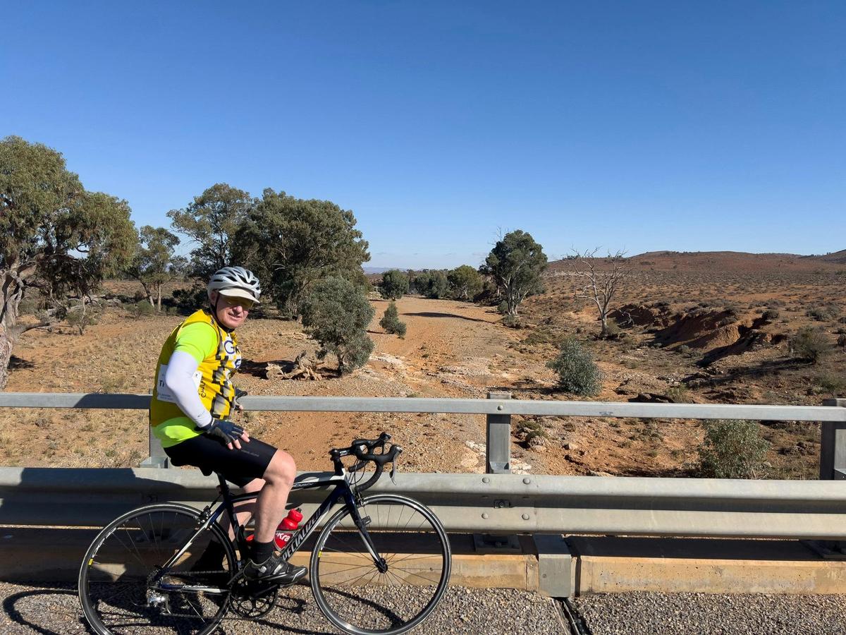 Cyclist resting for a photo with the view looking over the Flinders