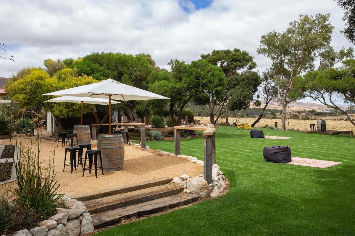 Outdoor area, including wine barrels, umbrellas, stools, rugs and beanbags