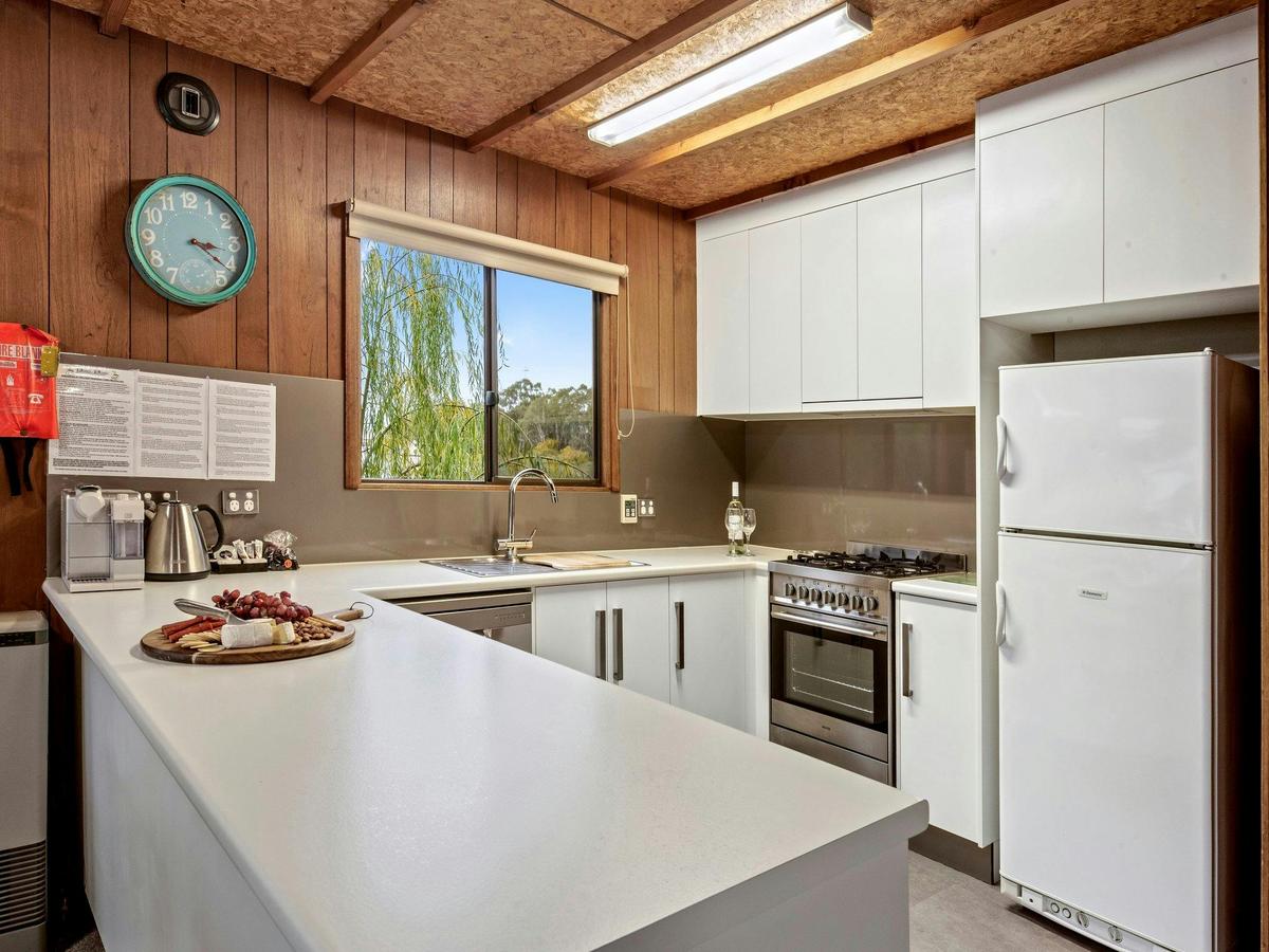 Fully equipped kitchen with large fridge, dishwasher and coffee machine