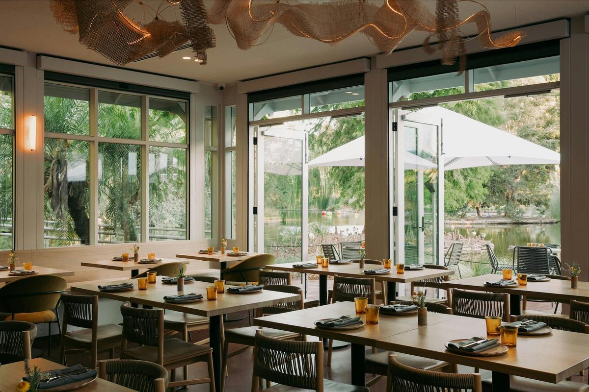 Light-filled dining room at Botanic Lodge overlooking the surrounding Adelaide Botanic Garden.
