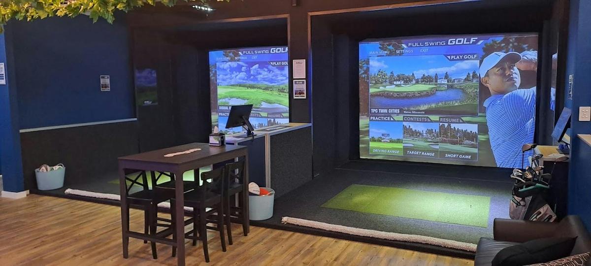 photo of 2 simulators next to eachother, showcasing our full swing software and seating area forgolf