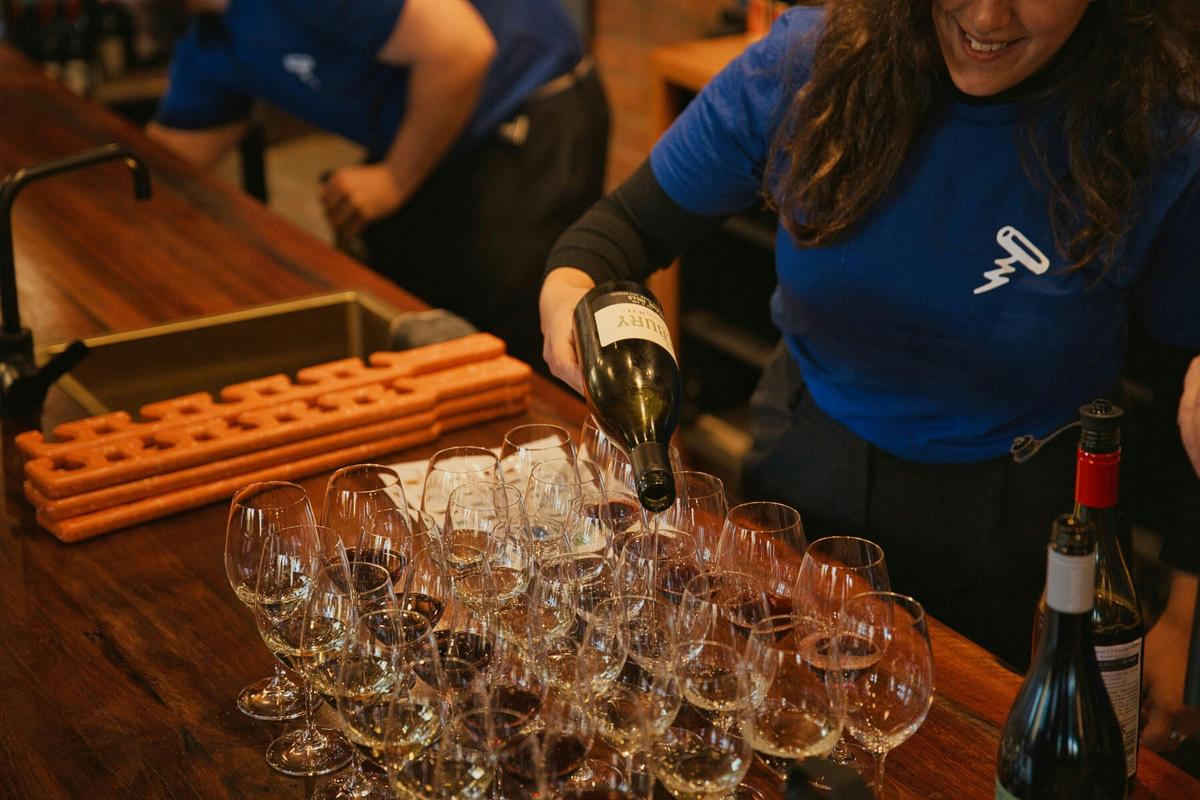 Staff members pour the wine tasting flights