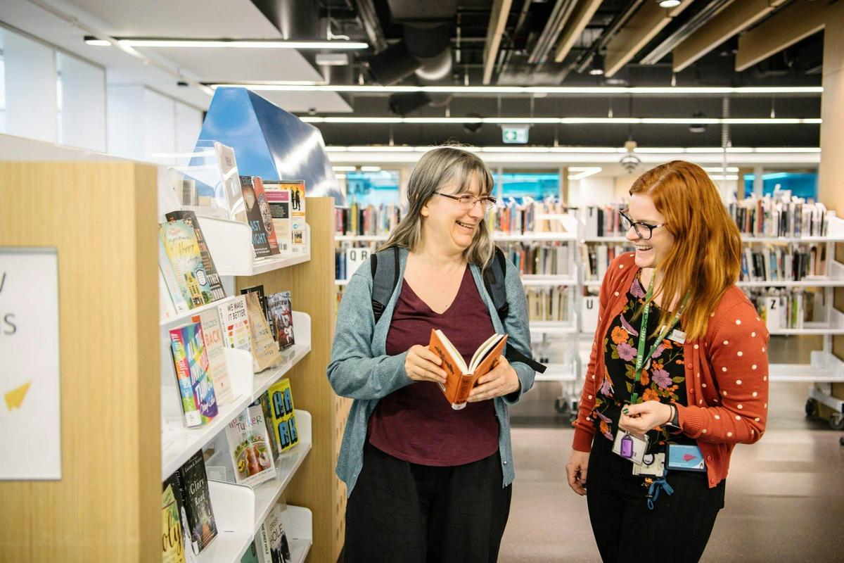 A library staff member helping a customer