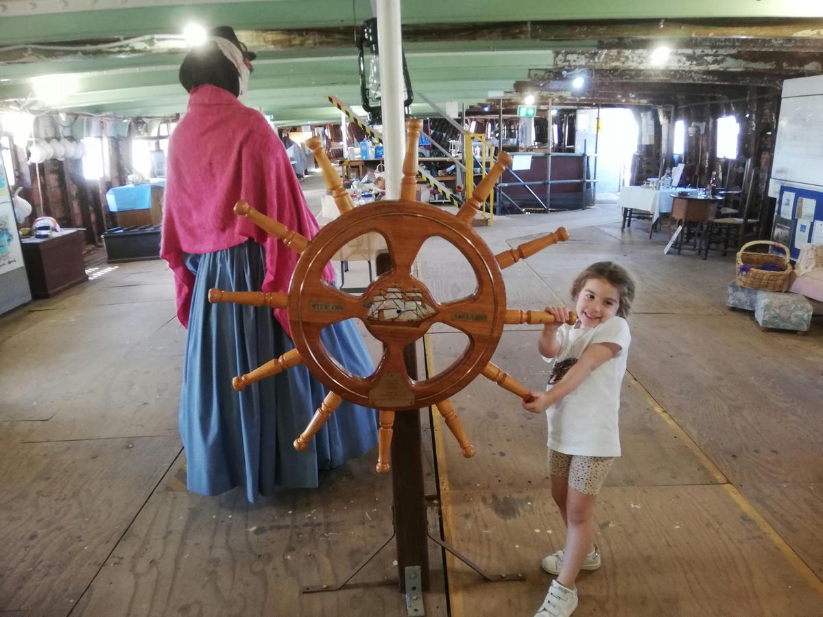 Child at mock ship steering wheel