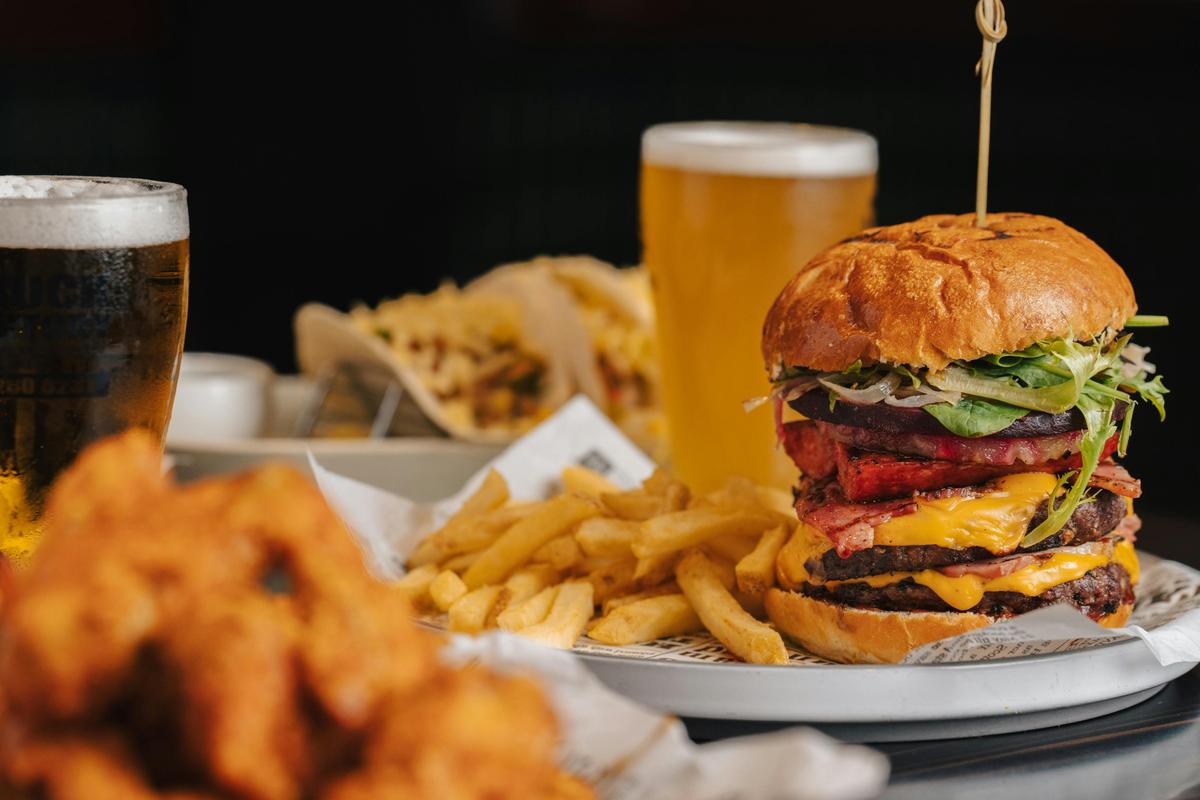 Savor the indulgent flavors of Cross Keys' burgers served with chips and best enjoyed with cold beer