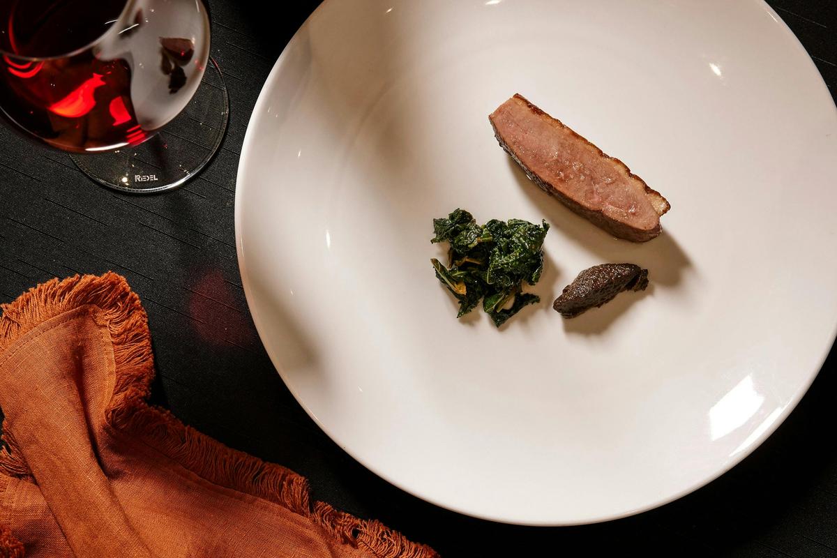 Tea Smoked Duck with fermented mushroom, plum kale