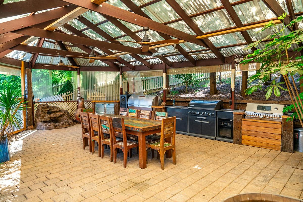 The covered outdoor kitchen and dining area seats the group at Funday Farm Adelaide Hill