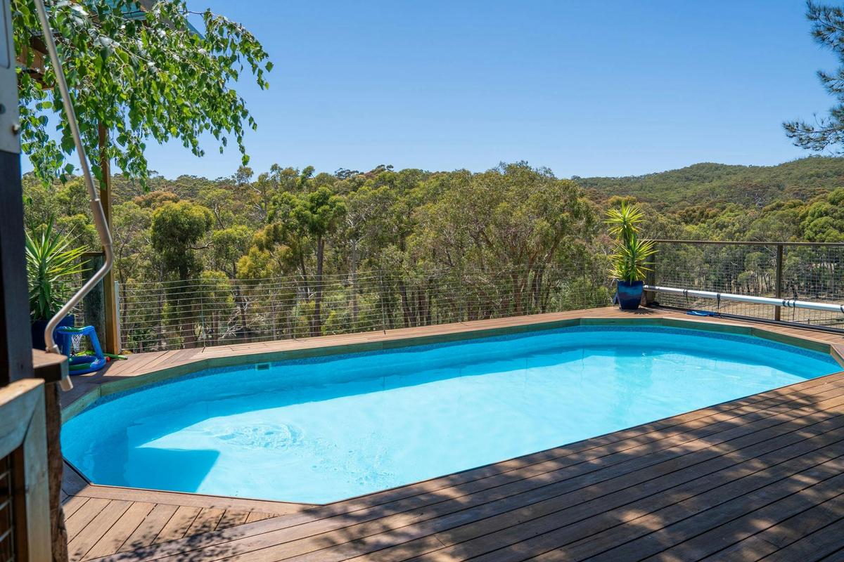 The heated saltwater pool and deck look out over gum forest at Norton Summit.