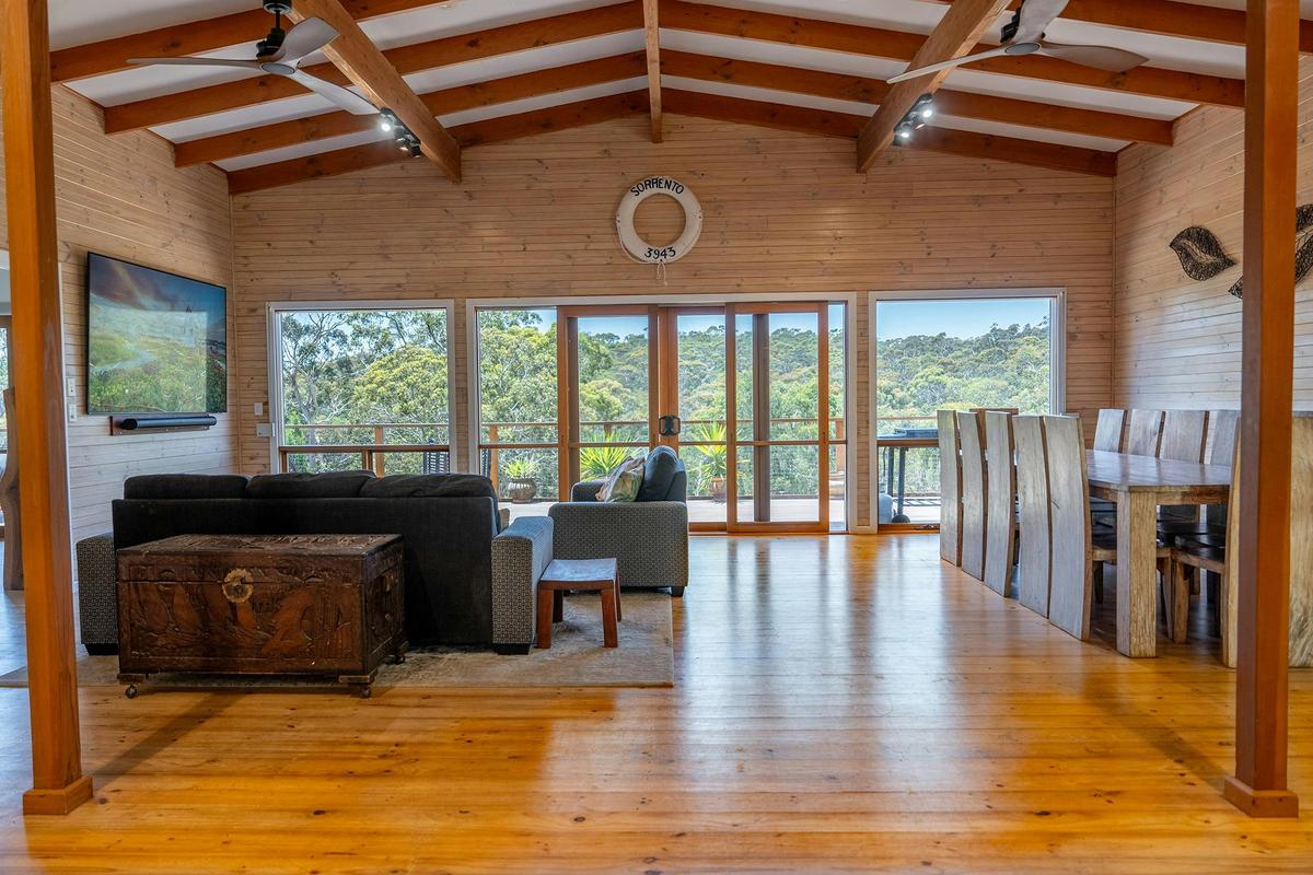 The upstairs living area at Funday Farm Adelaide Hills opens to a deck with forest views