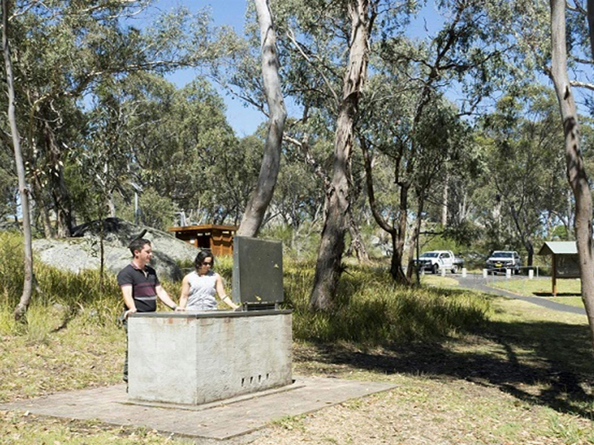 Two people at the barbecue, Threlfall picnic area, Oxley Wild Rivers National Park. Photo: Leah