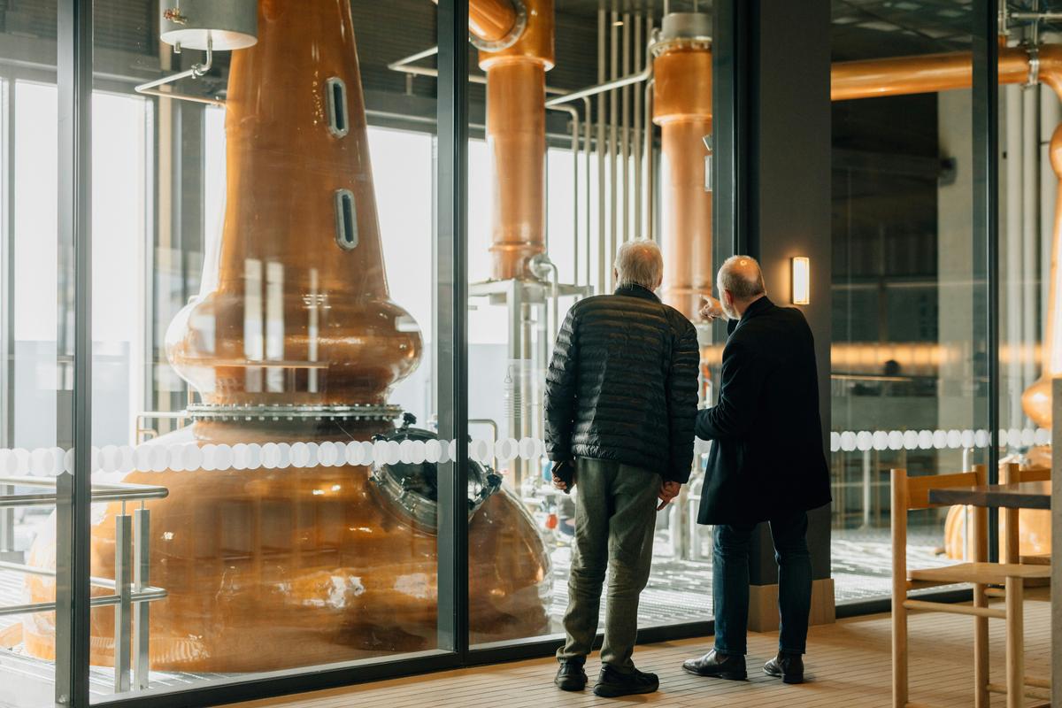People looking at whisky stills