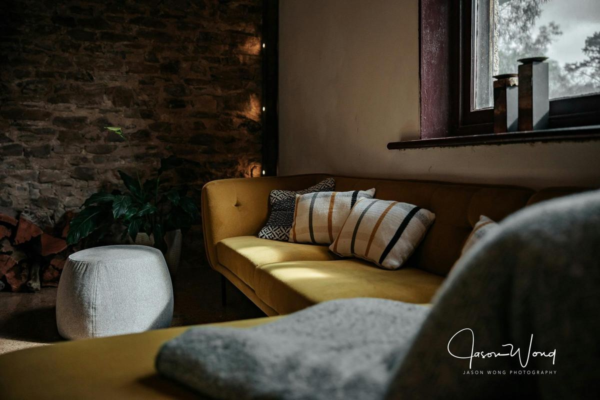 A comfy couch for reading or just staring in to the fireplace