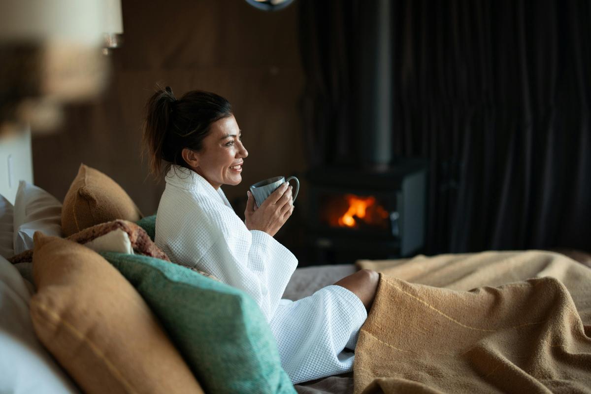 Guest sipping coffee by the fire