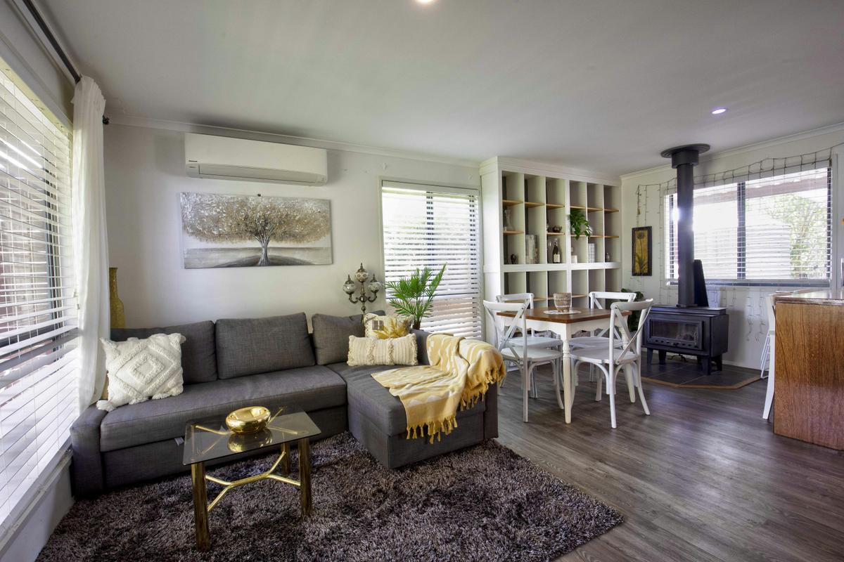 lounge with pull out bed, dining area and wood fire