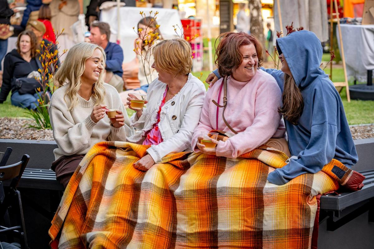 Handmade Christmas Market goers keeping warm under an Onkaparinga Woollen Mill blanket