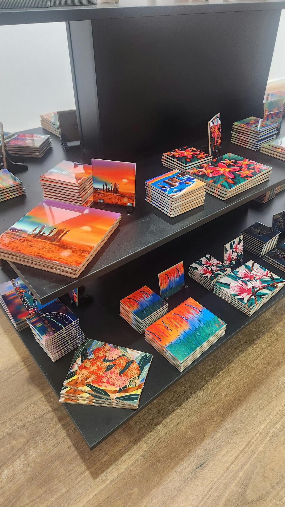 Examples of ceramic coasters and trivets with Grace's  colourful designs.
