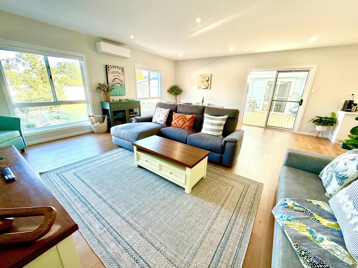 Spacious open plan living, dining, and kitchen area.