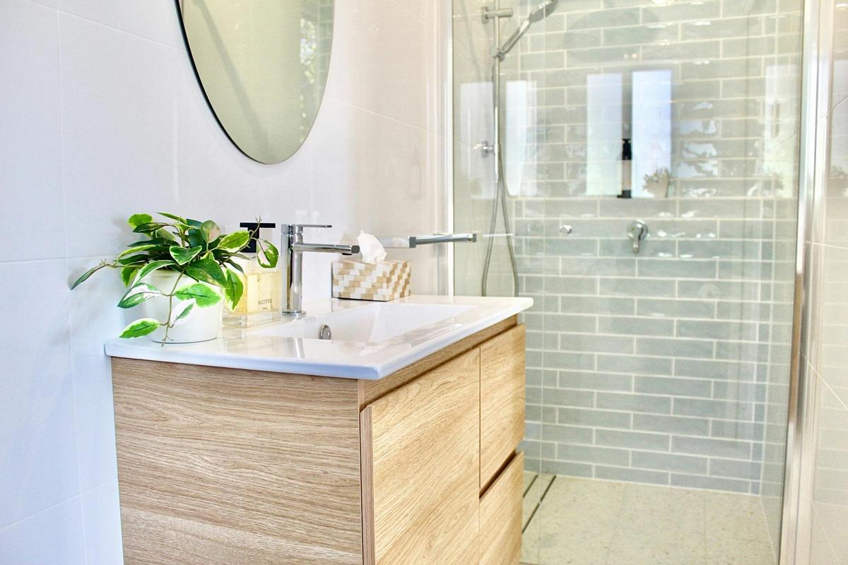 Modern ensuite with walk-in shower and vanity.