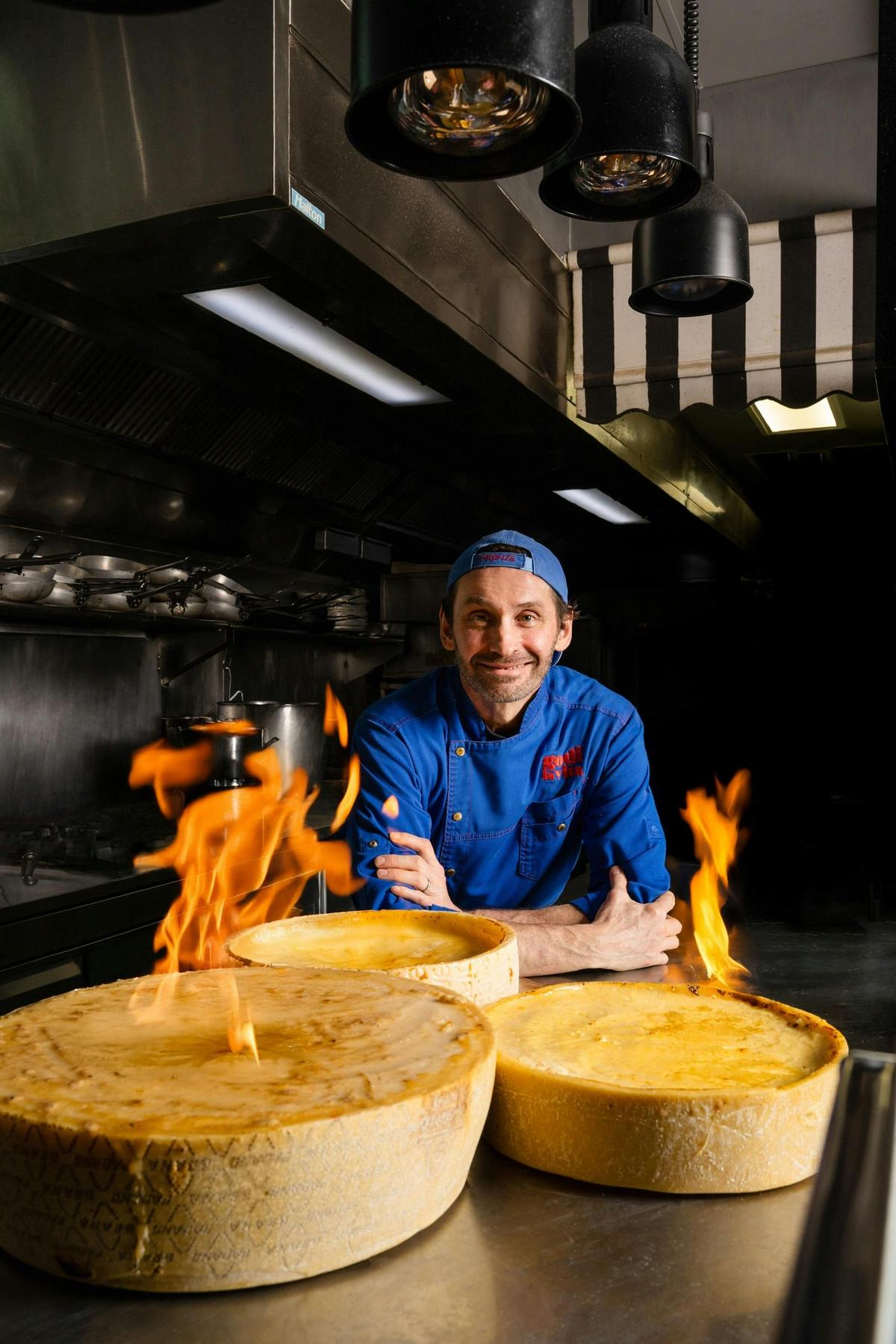 Head Chef Federico Godi with Flaming Cheese Wheel