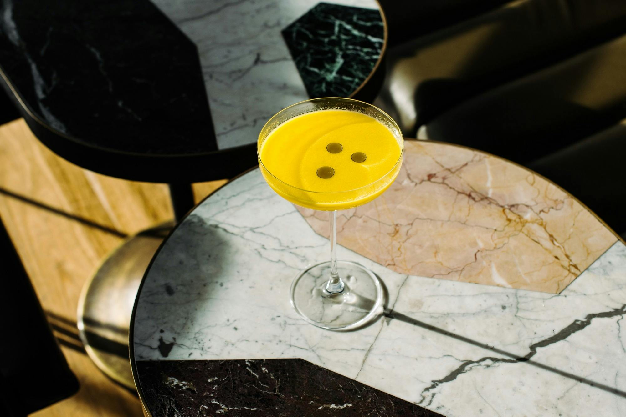 Yellow cocktail on table