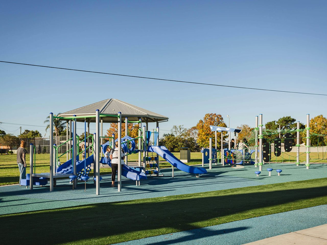 Families playing on equipment at park