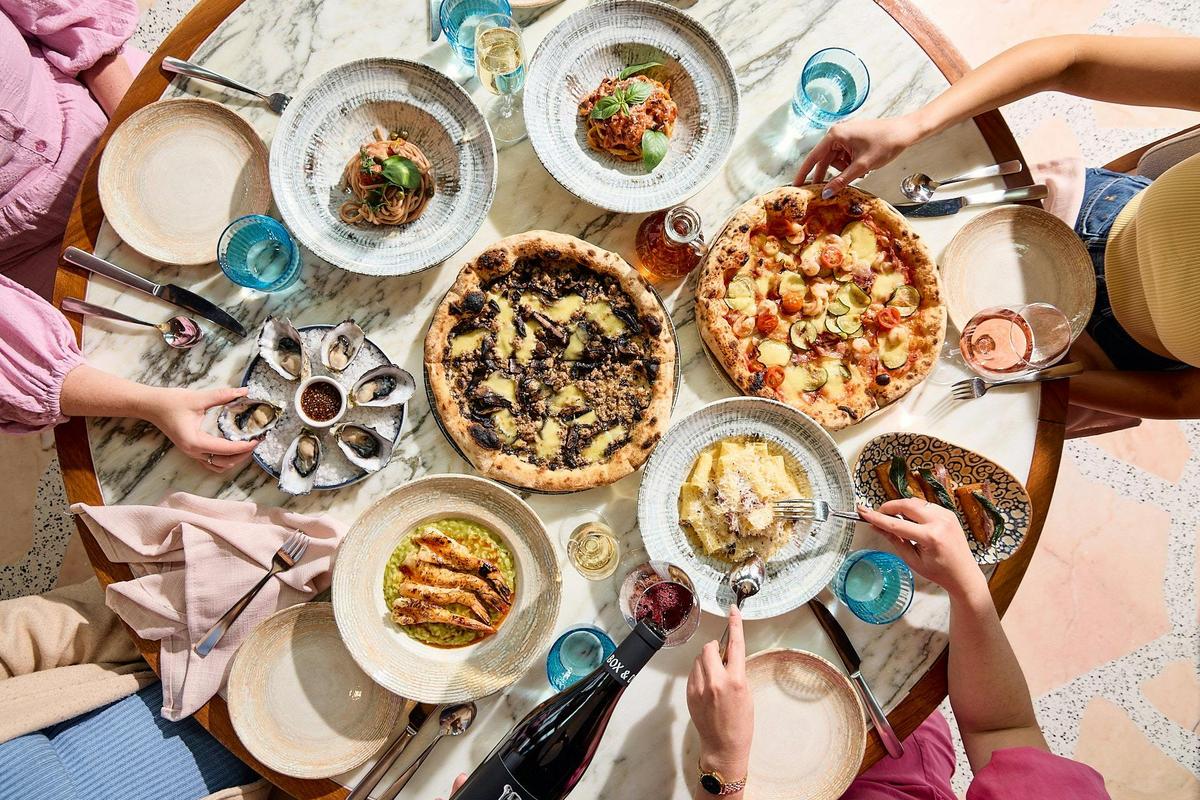 Table filled with Italian dishes.