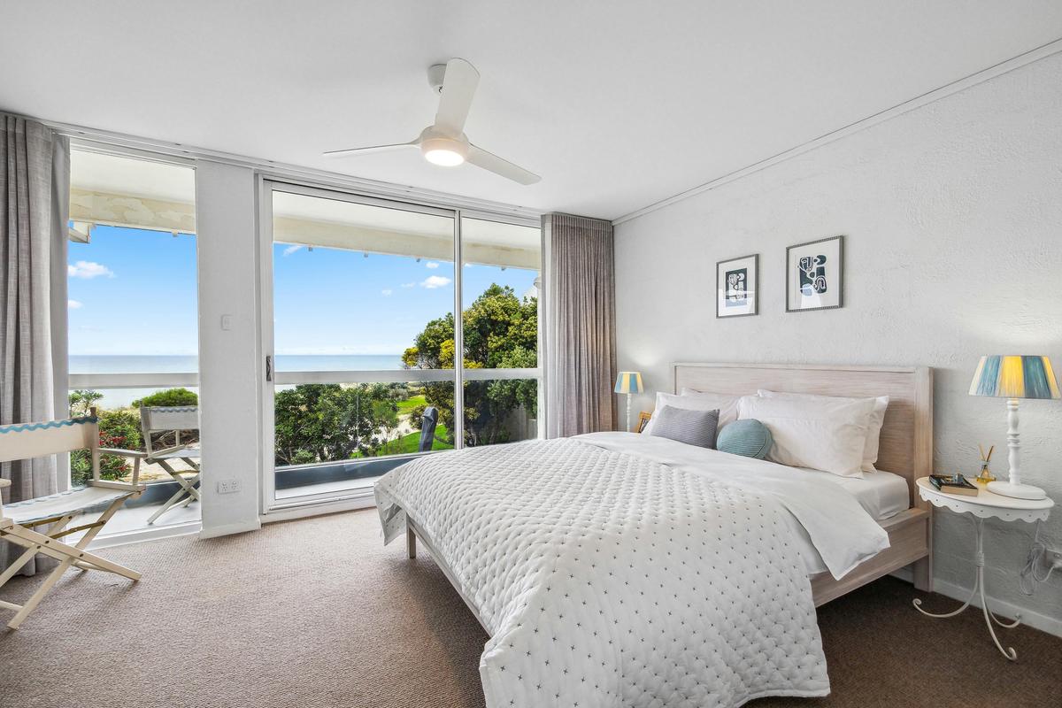 Bedroom 1 with a sea view, queen bed, ensuite and built in wardrobes