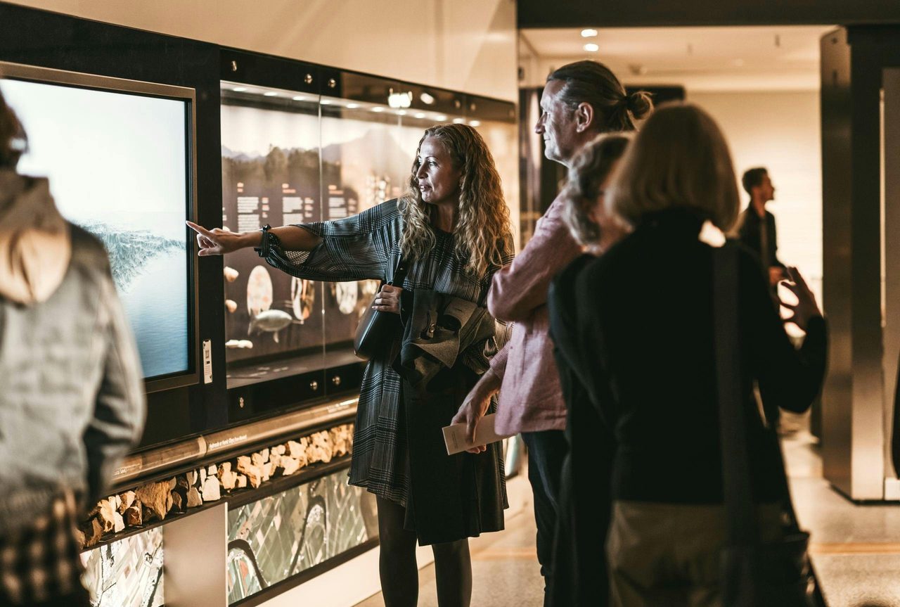 Visitors looking at Land Life Culture exhibition.