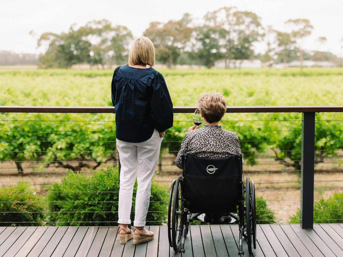 Daughter and mother in wheelchair enjoying the vineyard views on the accessible viewing deck