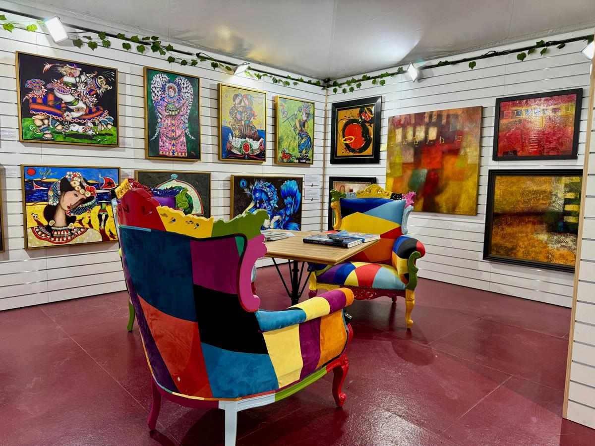 Three brightly coloured chairs surrounded by world renown artwork