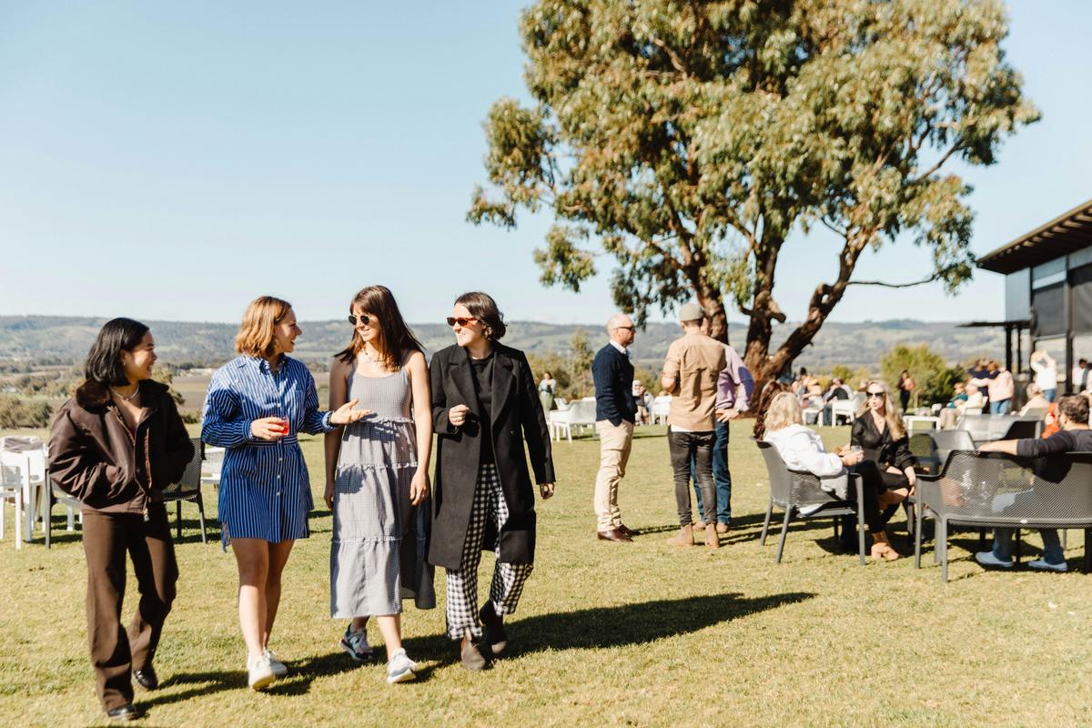 group of women walking on lawn with gin in hand