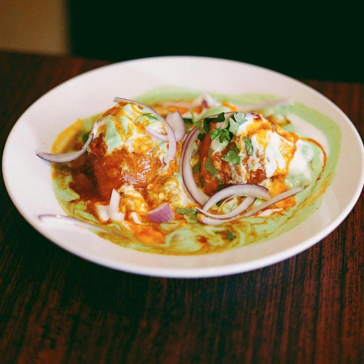 The New India Samosa Chaat,  served with Chole (chickpeas) and dressed with tangy chutneys.