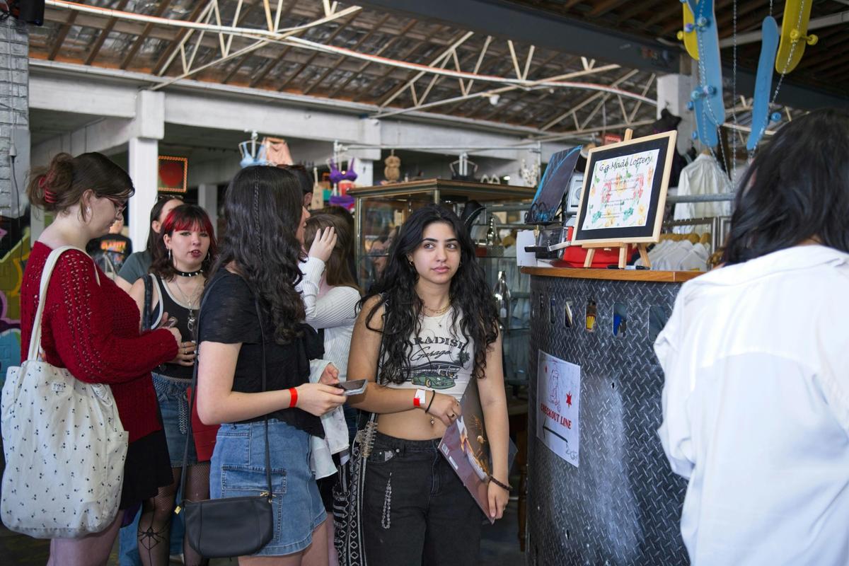 Teens queue at the checkout with vintage finds at My Dead Grandpa, Adelaide