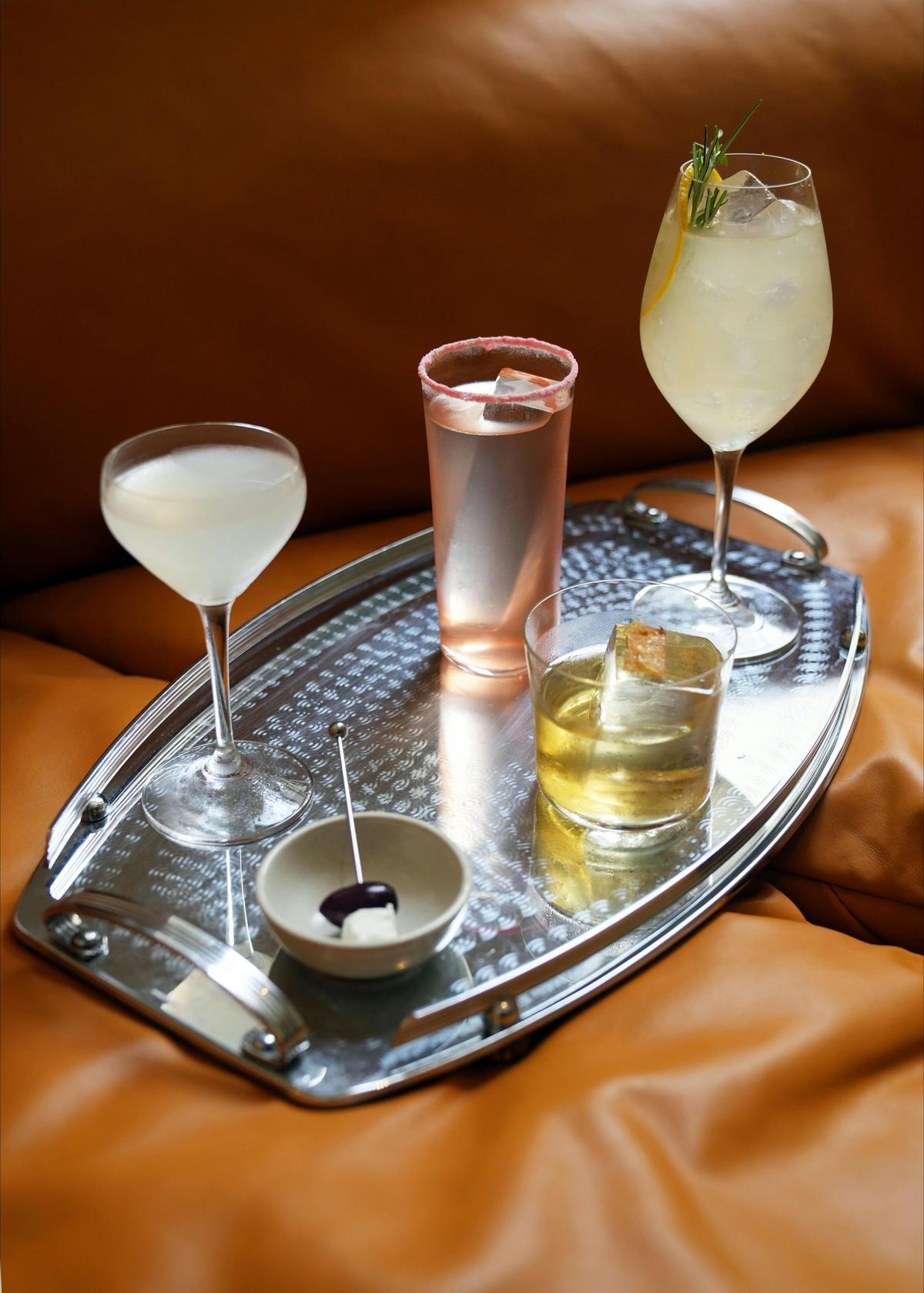 A tray of thoughtful cocktails at OMADA Bar & Grill