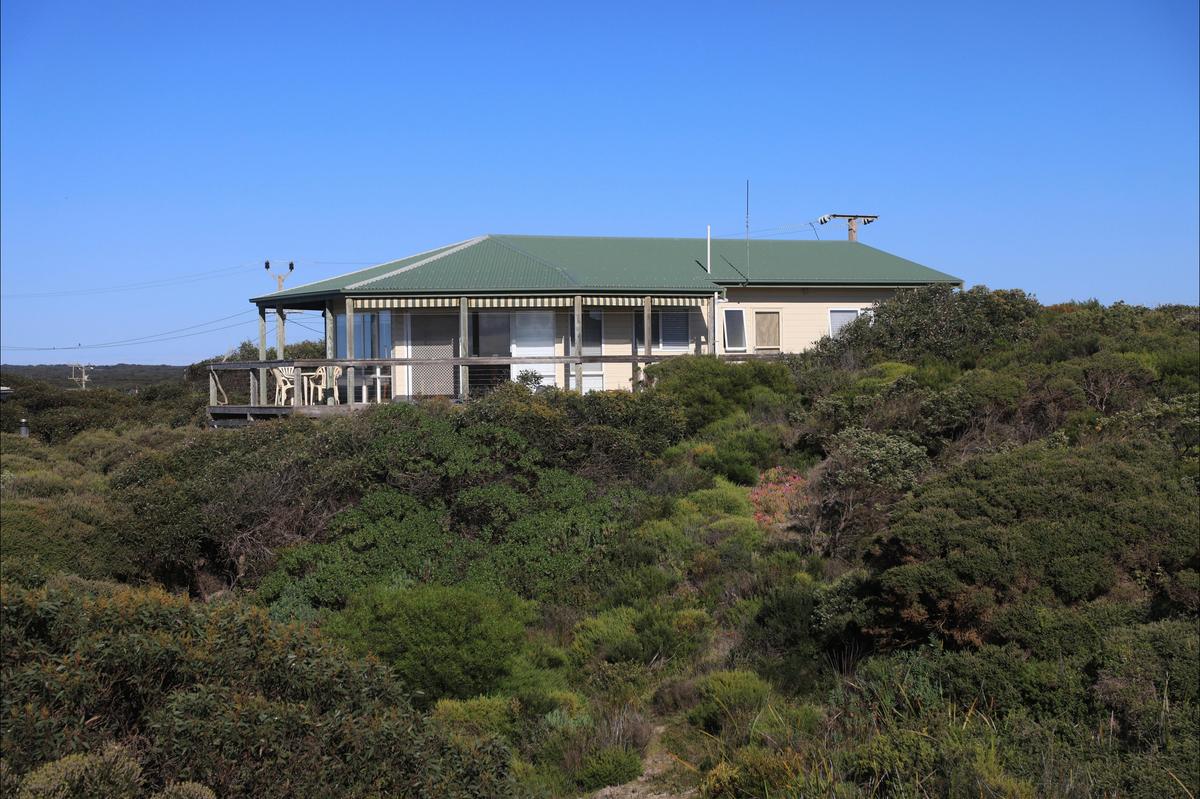 View of house set high amongst surrounding coastal vegetation