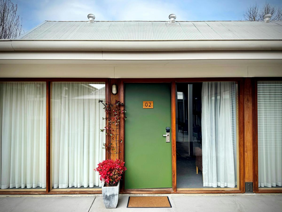 A green hotel room door