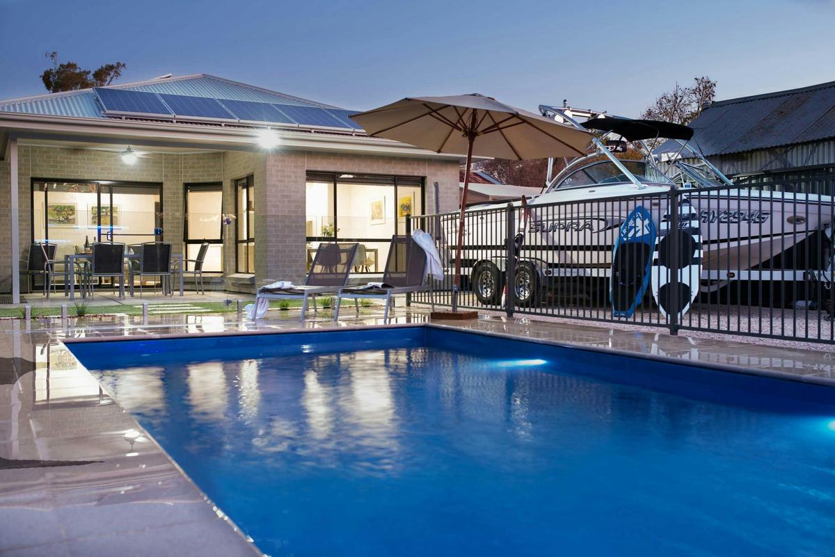 Rear yard of Villa 48B with alfresco area overlooking pool and parking space for speedboat & 2nd car