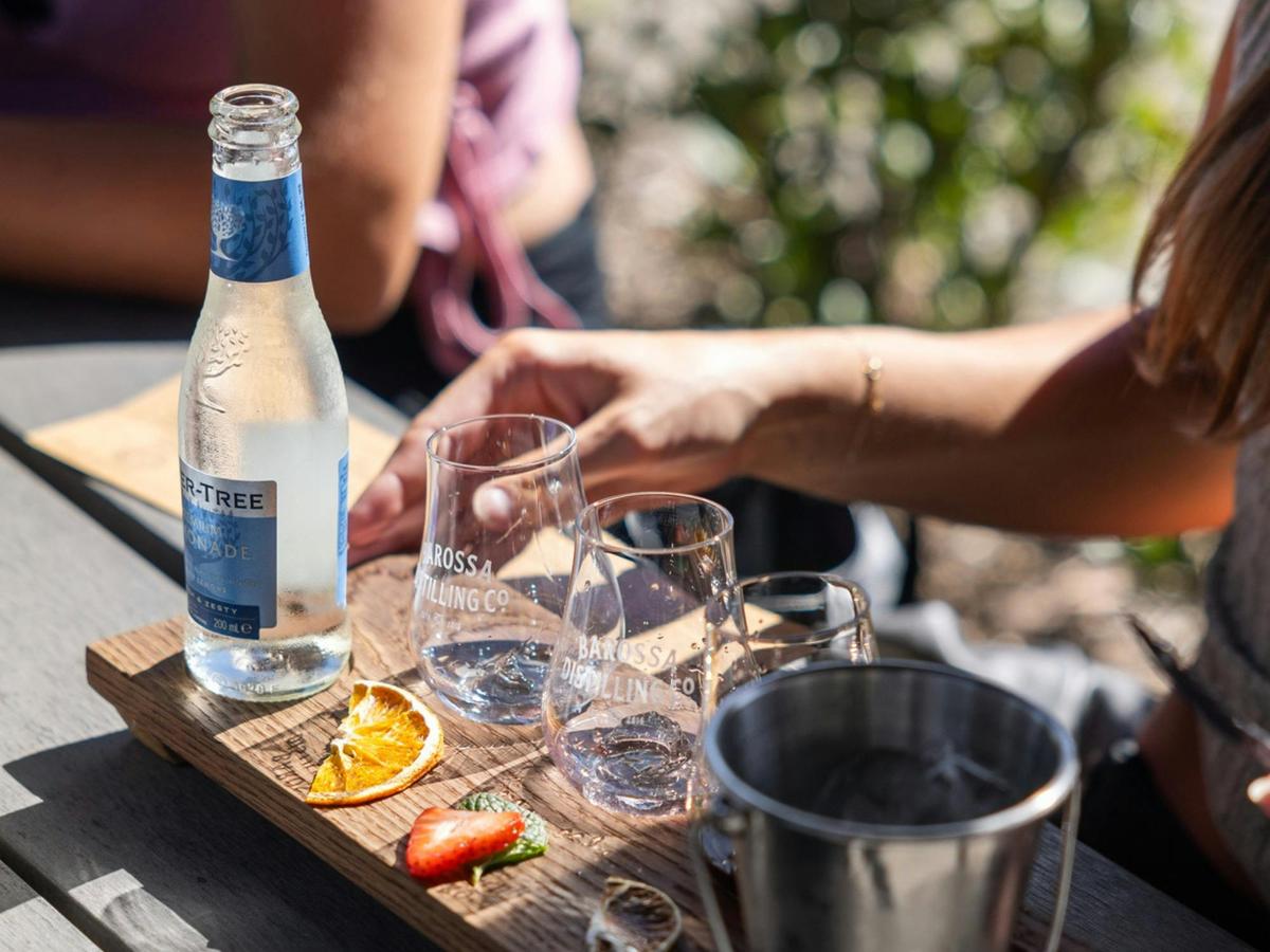 Woman enjoying a gin tasting paddle at Barossa Distilling Co.