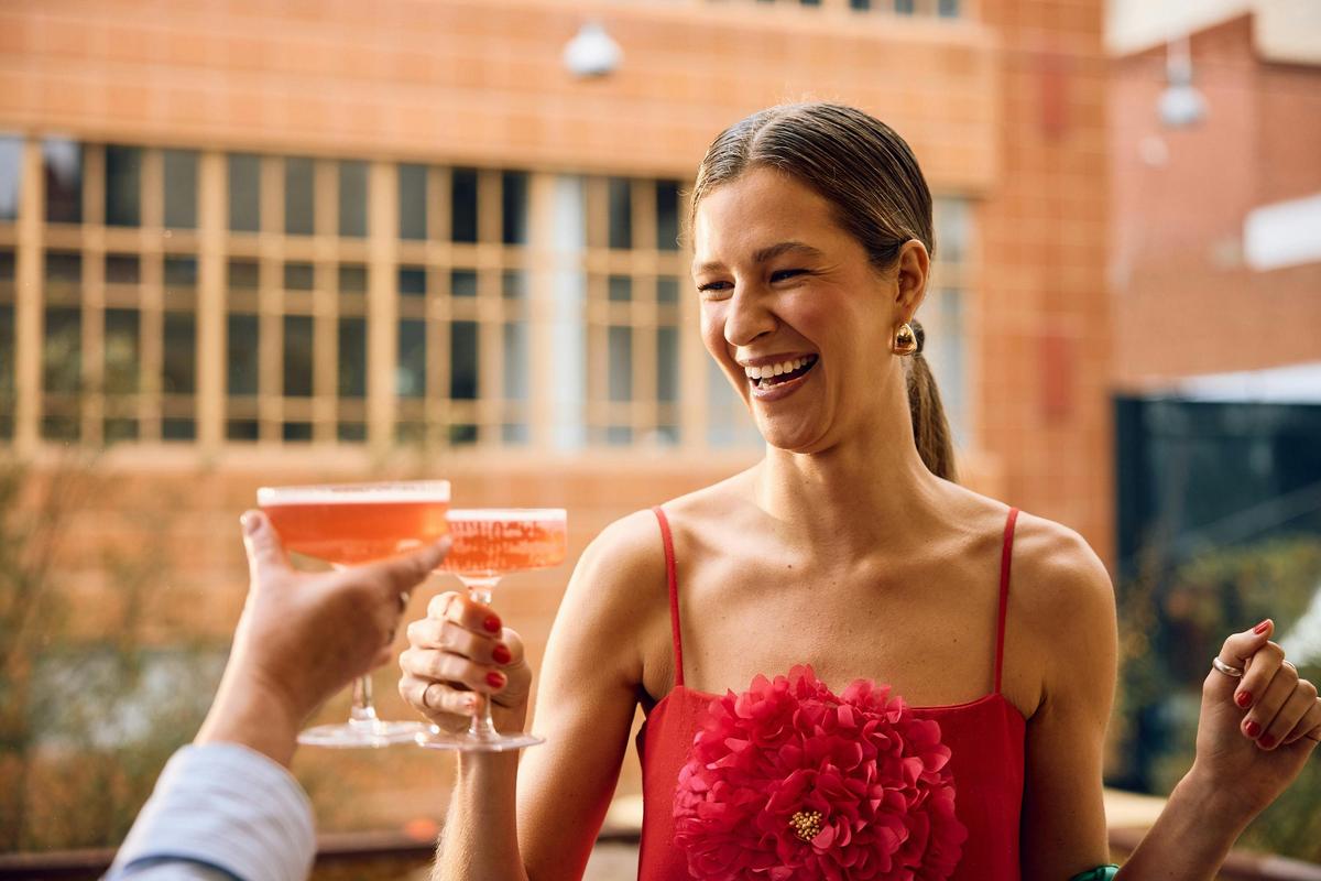Girl clinking her champagne coupe with someone else