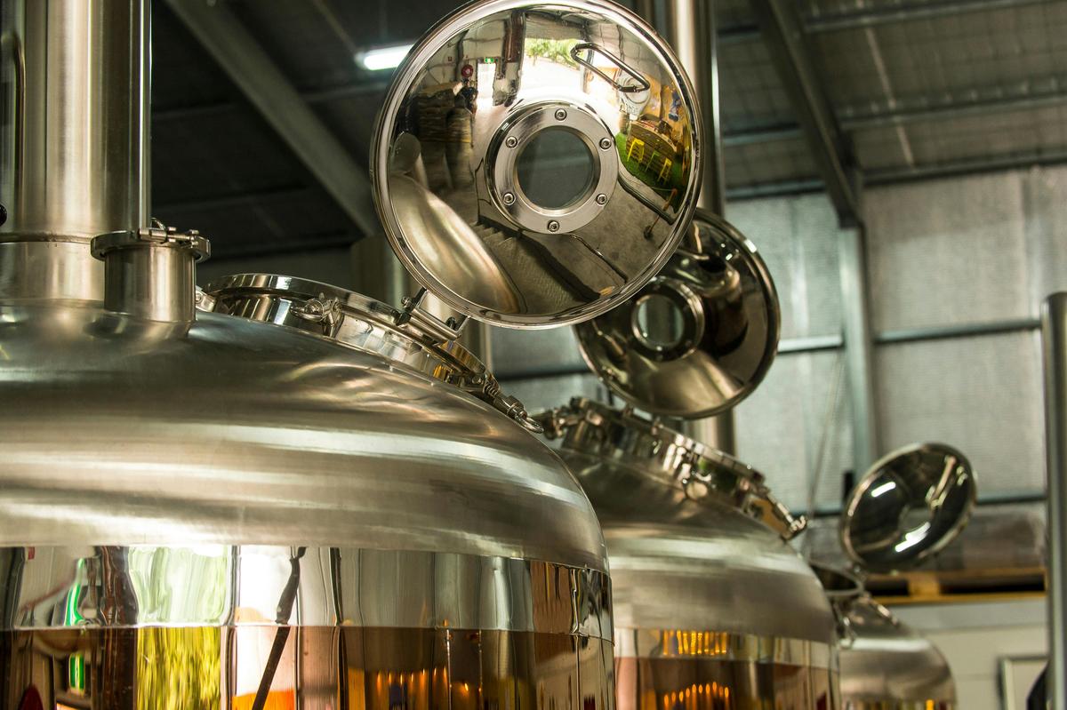 The shiny brewing vessels form a backdrop to the brewhouse cellardoor
