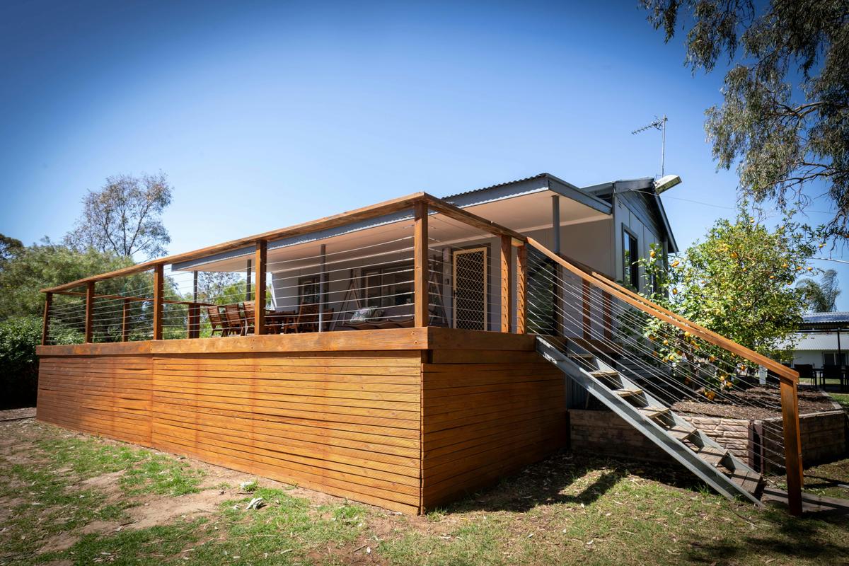 The home - two bedroom with large decking central to the holiday village