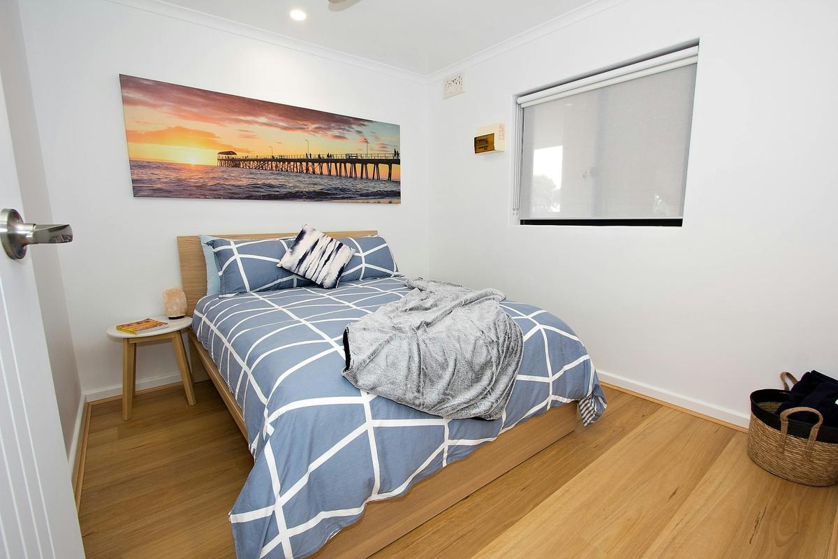 2nd bedroom with double bed, side tables, lamps, clothes rack