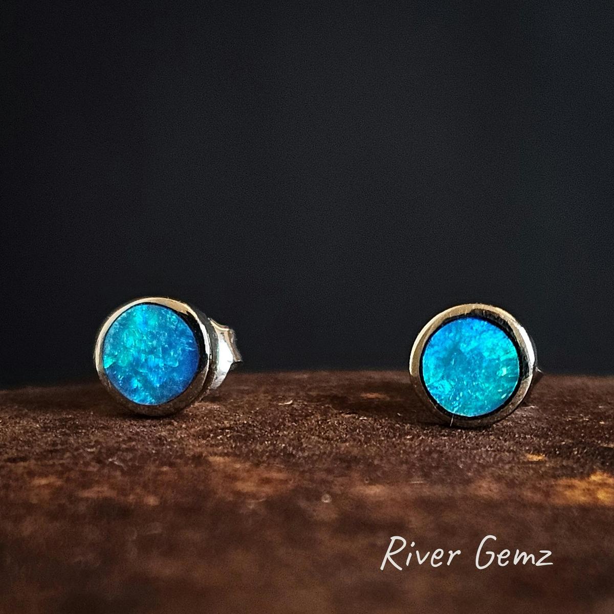 Blue and green crystal opals besel set in gold studs.