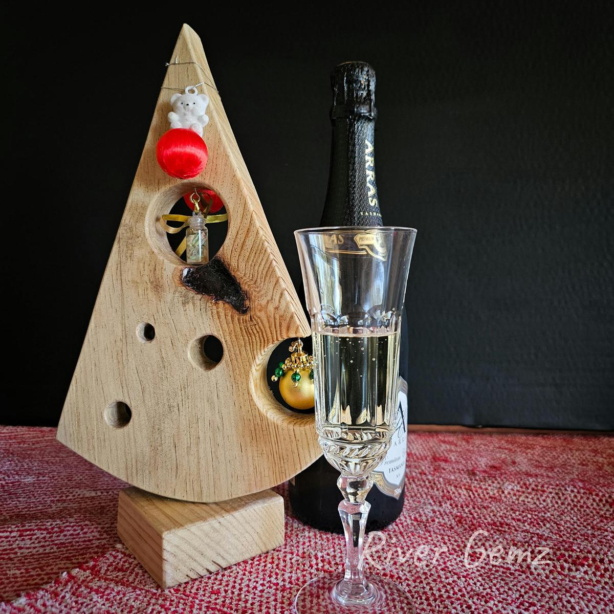 Vial of opal chips in pine table top Christmas tree