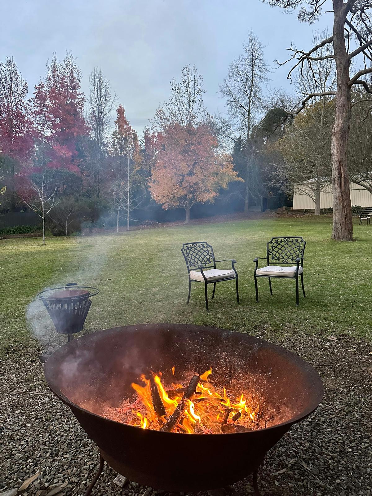 Warm up next to the outdoor fire pit in the picturesque garden