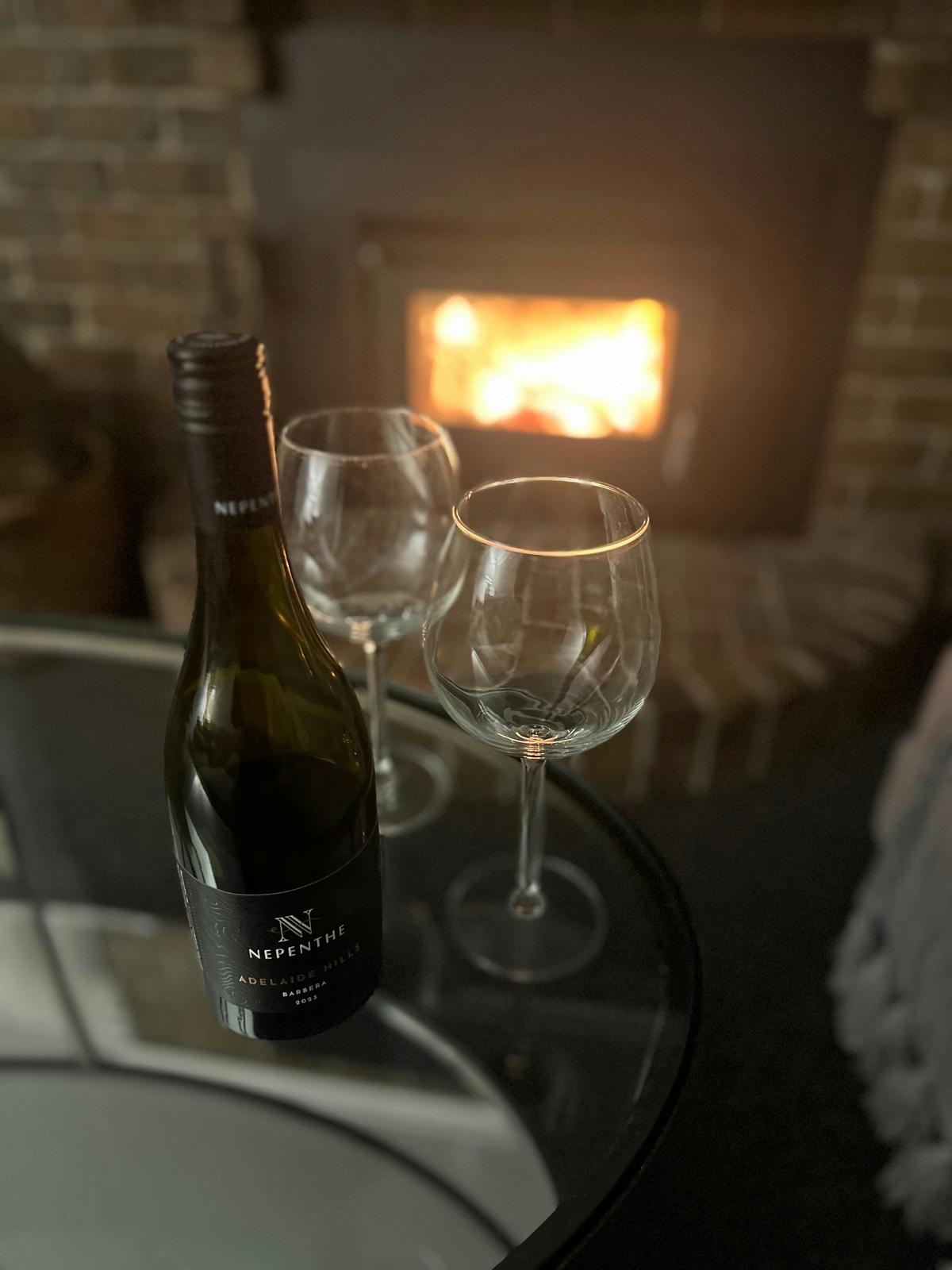 Enjoy a glass of wine by the cosy fire