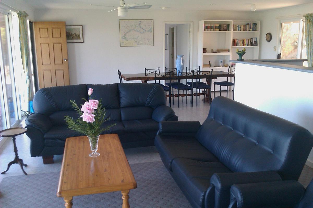 The spacious lounge dining area features a redgum dining table which seats 8 people.