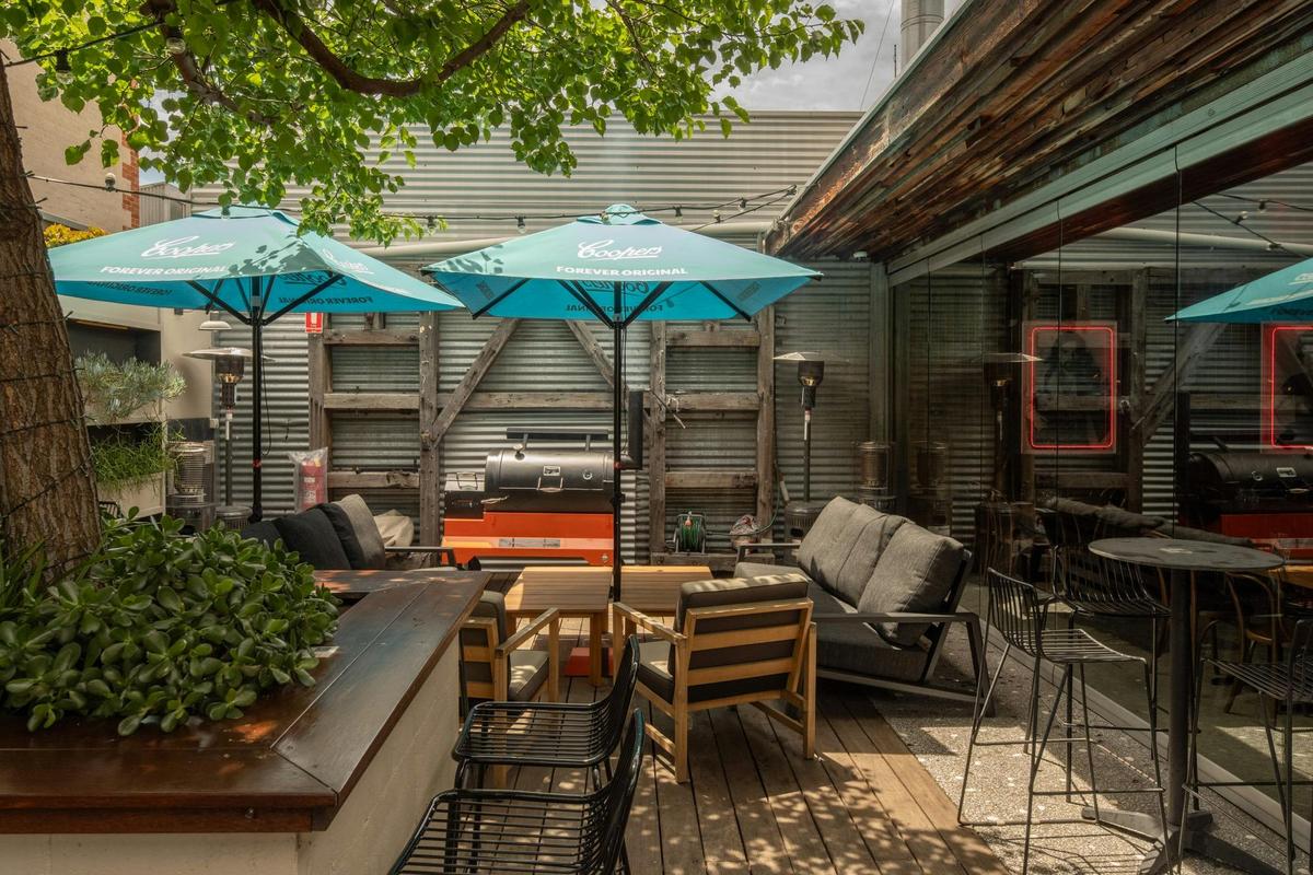 Relax under the shade in the Saracen's Head vibrant outdoor area, perfect for casual gatherings.